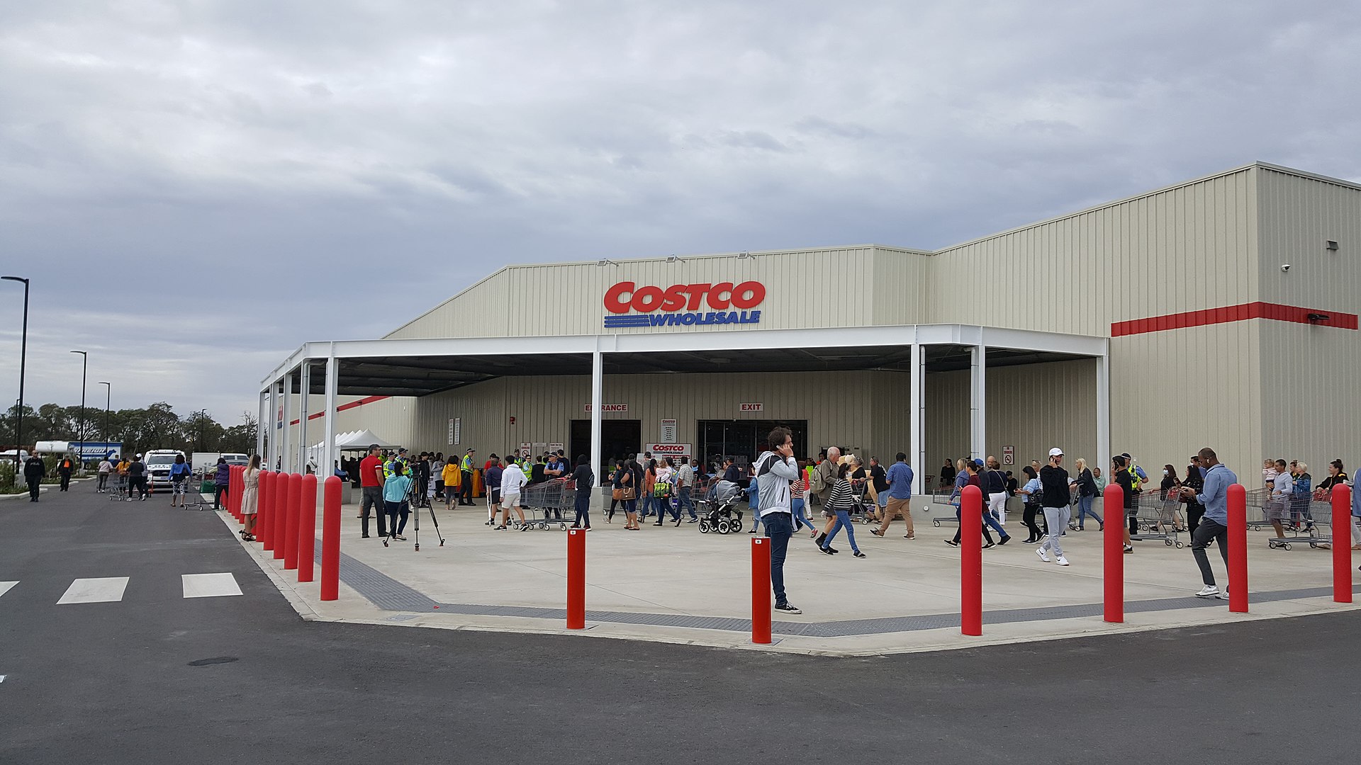 Front entrance of a Costco warehouse with people entering